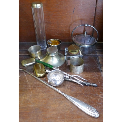 674 - A collection of plated items including inkwell, napkin rings, sovereign holder, pot, etc.