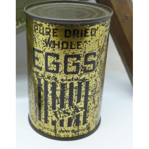 696 - A WWII rattle, ARP whistle and a tin of dried eggs