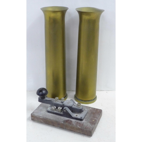 725 - A Morse Code device and a pair of brass WWII shell case vases