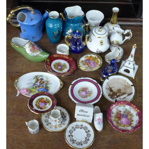 726 - A collection of Limoges china and a display case