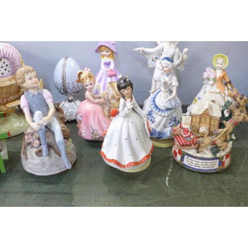 805 - Nine musical figurines, a pottery wagon and wooden cart