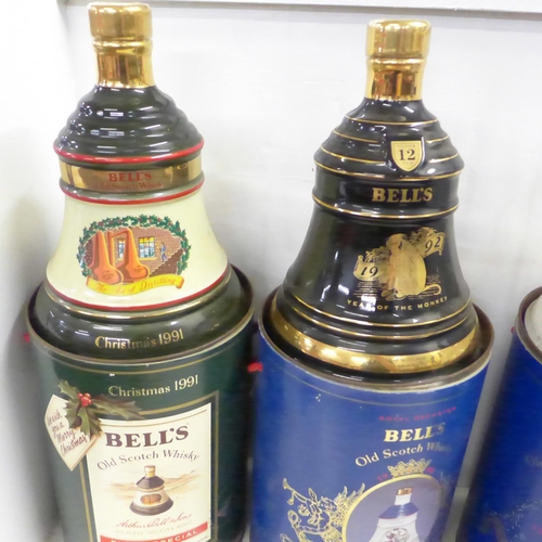 820 - Five Bell's Old Scotch Whisky decanters in containers; two Extra Special