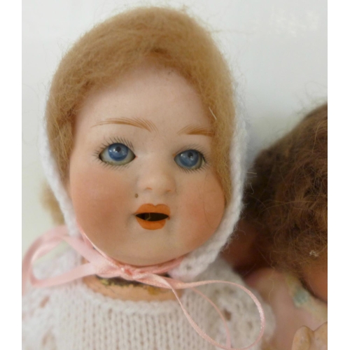 833 - Two dolls; a German Heubach bisque head doll with pale blue sleep eyes, 500 14/0 identification mark... 