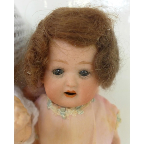 833 - Two dolls; a German Heubach bisque head doll with pale blue sleep eyes, 500 14/0 identification mark... 