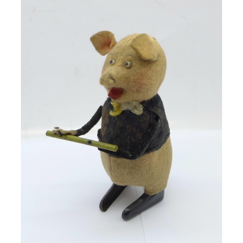 846 - A Schuco clockwork flute playing pig toy, made in Germany