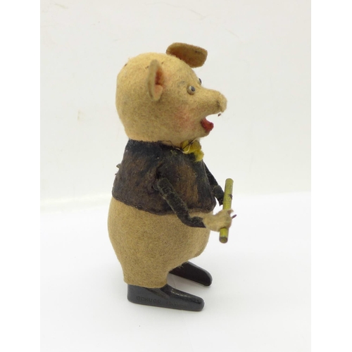 846 - A Schuco clockwork flute playing pig toy, made in Germany