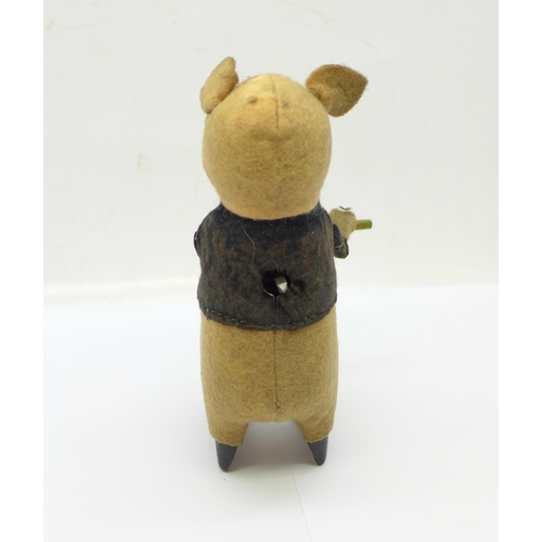 846 - A Schuco clockwork flute playing pig toy, made in Germany