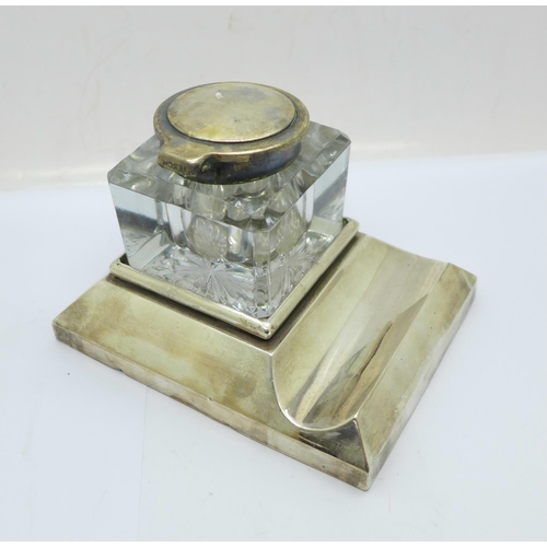 849 - A silver ink stand, Chester 1910, the glass inkwell with plated top