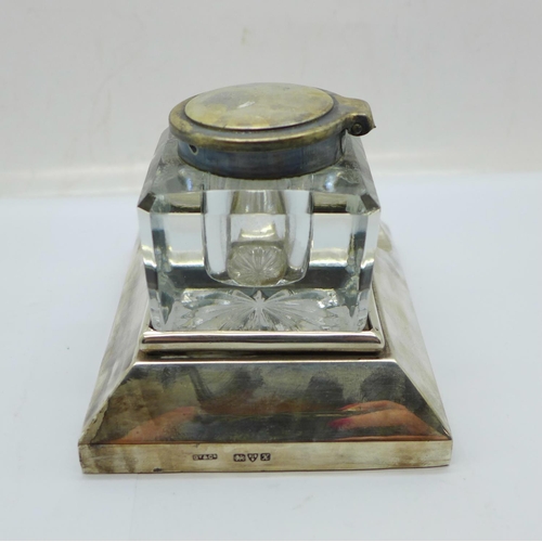 849 - A silver ink stand, Chester 1910, the glass inkwell with plated top