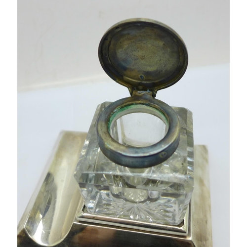 849 - A silver ink stand, Chester 1910, the glass inkwell with plated top