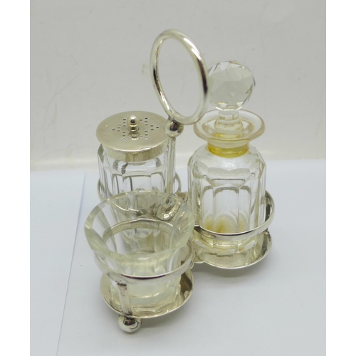 850 - A silver three bottle cruet stand, Chester 1909, 65g, the silver topped pepper with Birmingham hallm... 