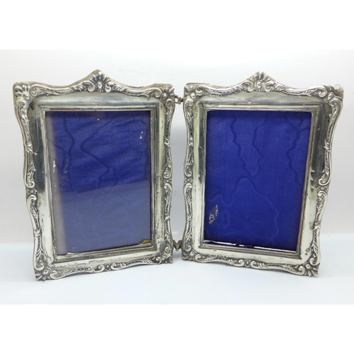 854 - A twin silver photograph frame, Birmingham 1904, one lacking glass, height 19.5cm, (some a/f, back w... 