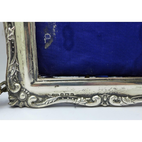 854 - A twin silver photograph frame, Birmingham 1904, one lacking glass, height 19.5cm, (some a/f, back w... 