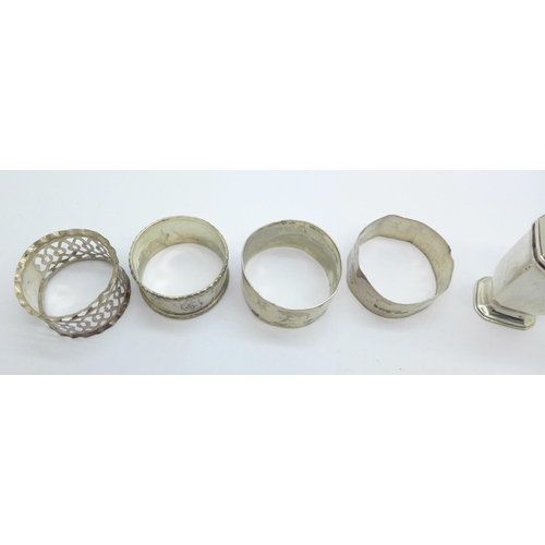 900 - Four silver napkin rings, two a/f, and a silver pepper, 115g