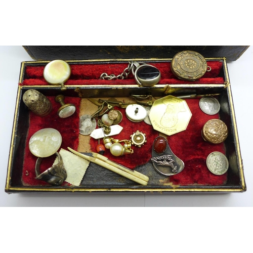 915 - A jewellery box with jewellery, etc., including a silver caddy spoon with replacement handle, a swiv... 