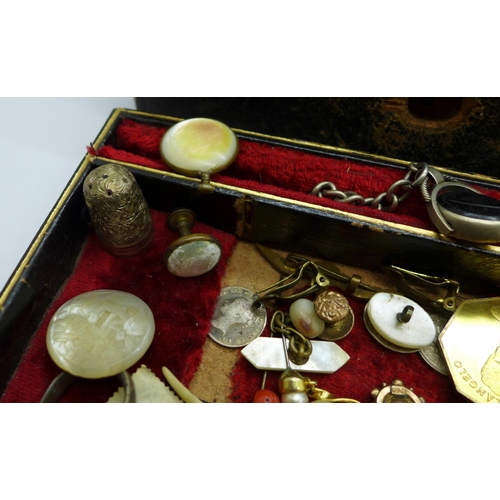 915 - A jewellery box with jewellery, etc., including a silver caddy spoon with replacement handle, a swiv... 