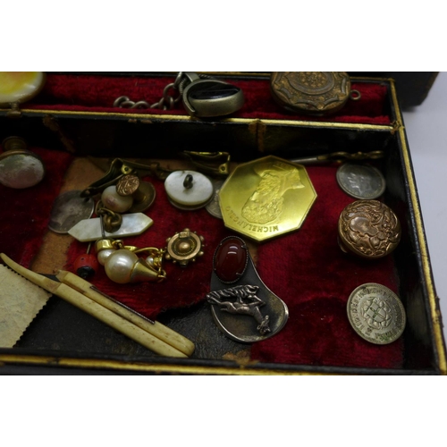 915 - A jewellery box with jewellery, etc., including a silver caddy spoon with replacement handle, a swiv... 