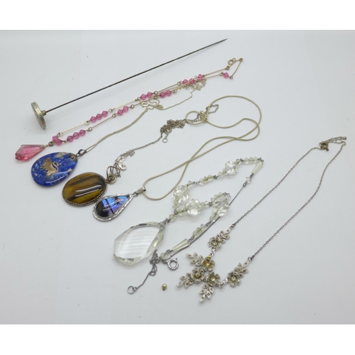 917 - Jewellery including a hat pin, silver mounted pendants, butterfly wing pendant and three necklets