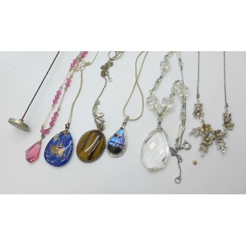 917 - Jewellery including a hat pin, silver mounted pendants, butterfly wing pendant and three necklets