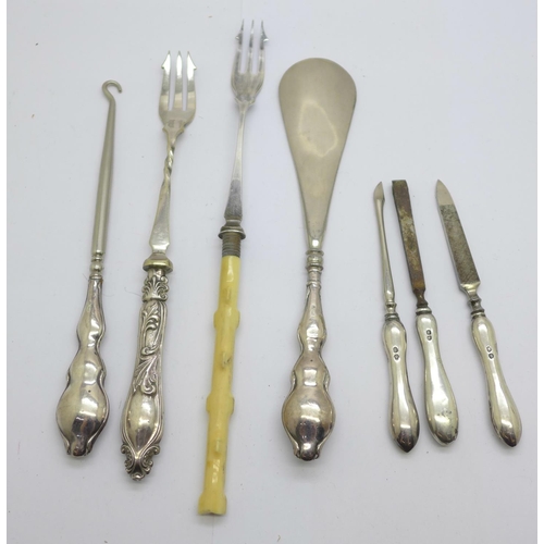 924 - Three silver manicures, a silver handled shoe horn and button hook and two forks