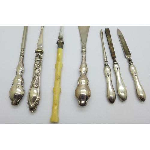 924 - Three silver manicures, a silver handled shoe horn and button hook and two forks