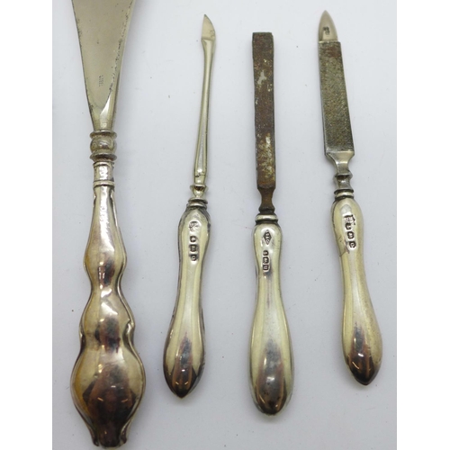 924 - Three silver manicures, a silver handled shoe horn and button hook and two forks