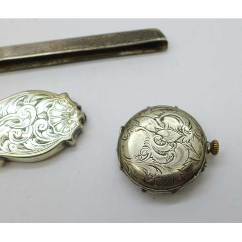 925 - A silver cased watch, a/f, a Victorian silver handle, a silver comb back and a silver and mother of ... 