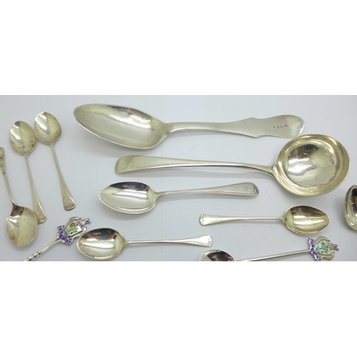 929 - A collection of silver spoons including a Georgian ladle, a large continental spoon, tea spoons, con... 