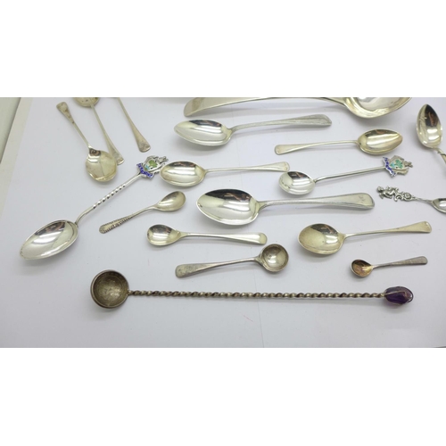 929 - A collection of silver spoons including a Georgian ladle, a large continental spoon, tea spoons, con... 