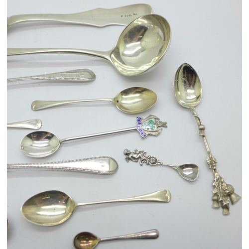 929 - A collection of silver spoons including a Georgian ladle, a large continental spoon, tea spoons, con... 