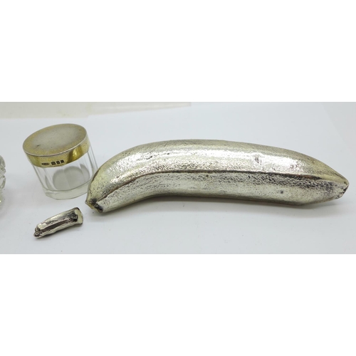 930 - A silver banana (silver covered, marked 'Filled'), a/f, a silver rimmed salt and a silver topped gla... 