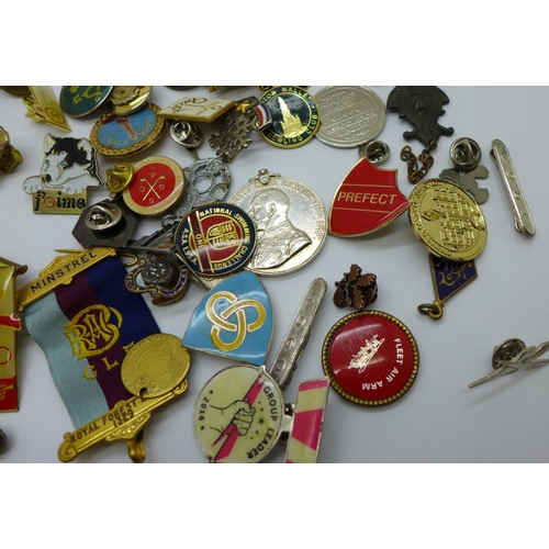 963 - A collection of badges and medallions, etc.