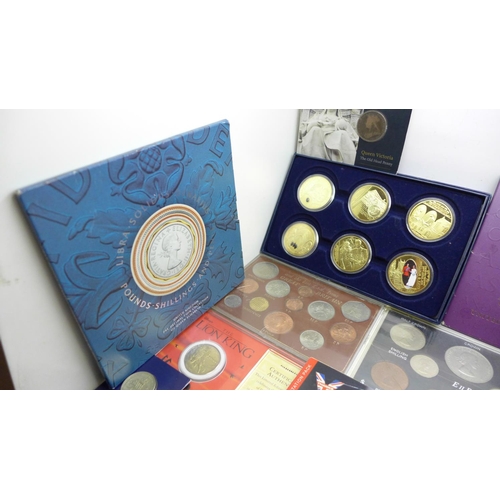 978 - A collection of commemorative coin sets including four £5 coins, a 2002 UK Brilliant Uncirculated Co... 