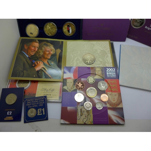 978 - A collection of commemorative coin sets including four £5 coins, a 2002 UK Brilliant Uncirculated Co... 