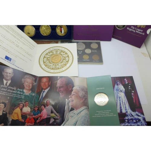 978 - A collection of commemorative coin sets including four £5 coins, a 2002 UK Brilliant Uncirculated Co... 