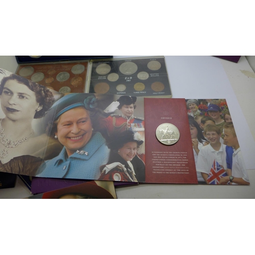 978 - A collection of commemorative coin sets including four £5 coins, a 2002 UK Brilliant Uncirculated Co... 