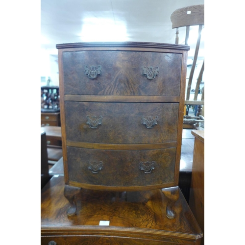 106 - A small burr walnut bow front chest of drawers