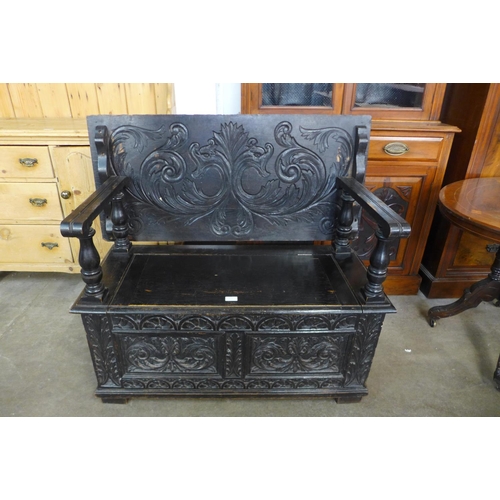 123 - A Jacobean Revival carved oak monk's bench