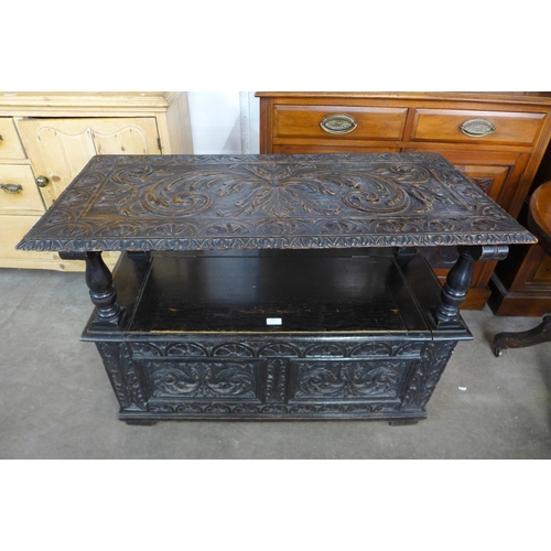 123 - A Jacobean Revival carved oak monk's bench