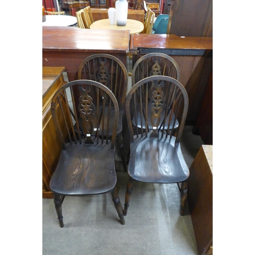 129 - A set of beech and elm wheelback kitchen chairs