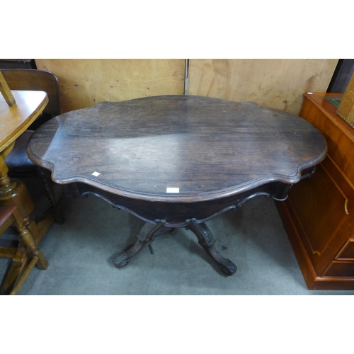 135 - A 19th Century French rosewood two drawer serpentine centre table