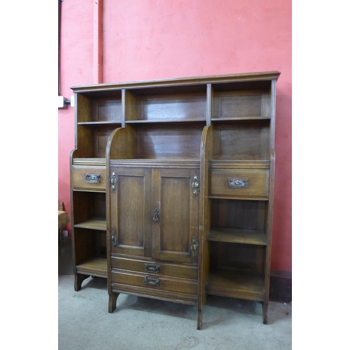 14 - An Arts and Crafts oak open breakfront bookcase