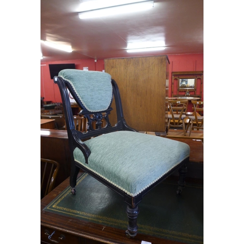 143a - A Victorian Aesthetic Movement ebonised and upholstered nursing chair