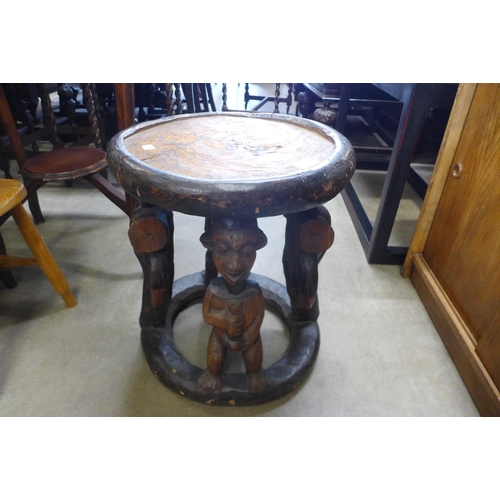 162 - An African carved softwood occasional table