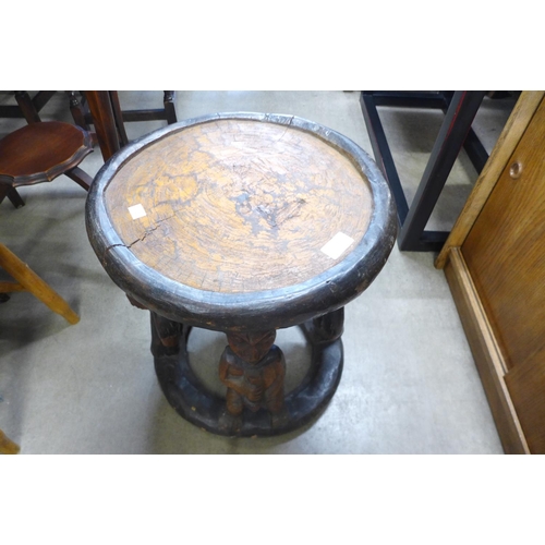 162 - An African carved softwood occasional table