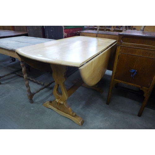 182 - An Ercol ash drop-leaf table