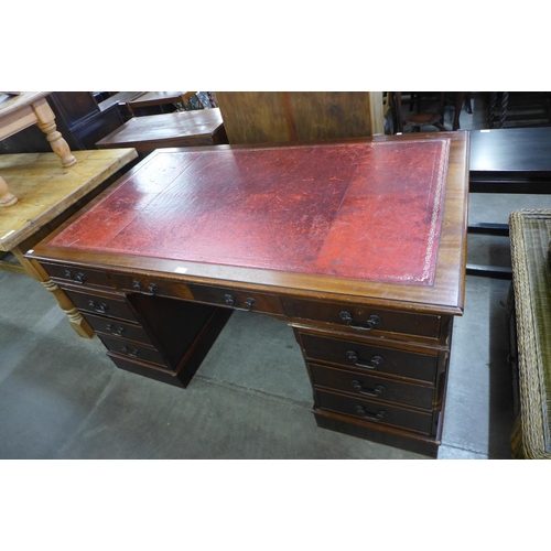 194 - A mahogany and red leather topped  library desk