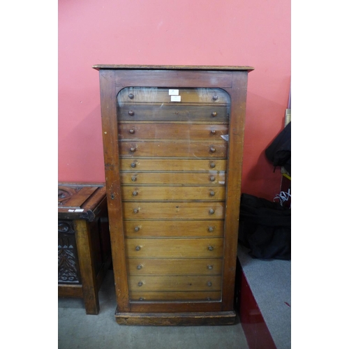 26 - A Victorian stained pine museum collectors cabinet, with single glazed door revealing thirteen drawe... 