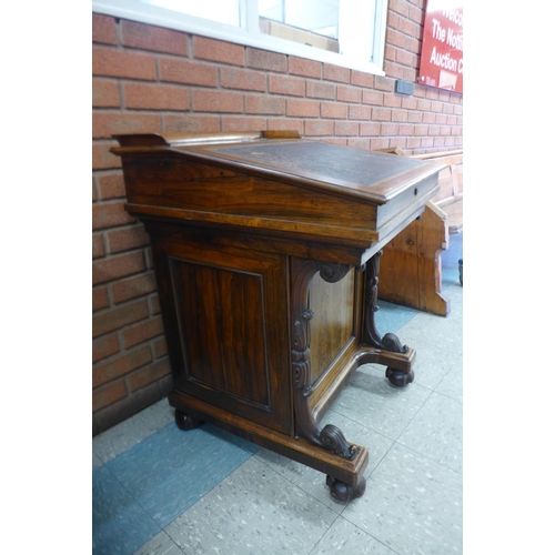 41b - A Victorian rosewood sliding top Davenport, stamped James Winter, 101 Wardour St., London