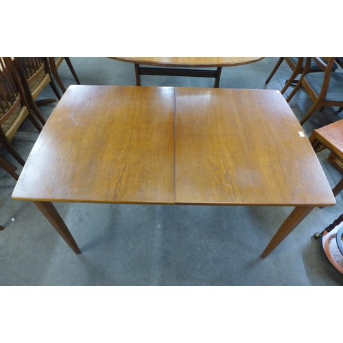 78 - A teak extending dining table